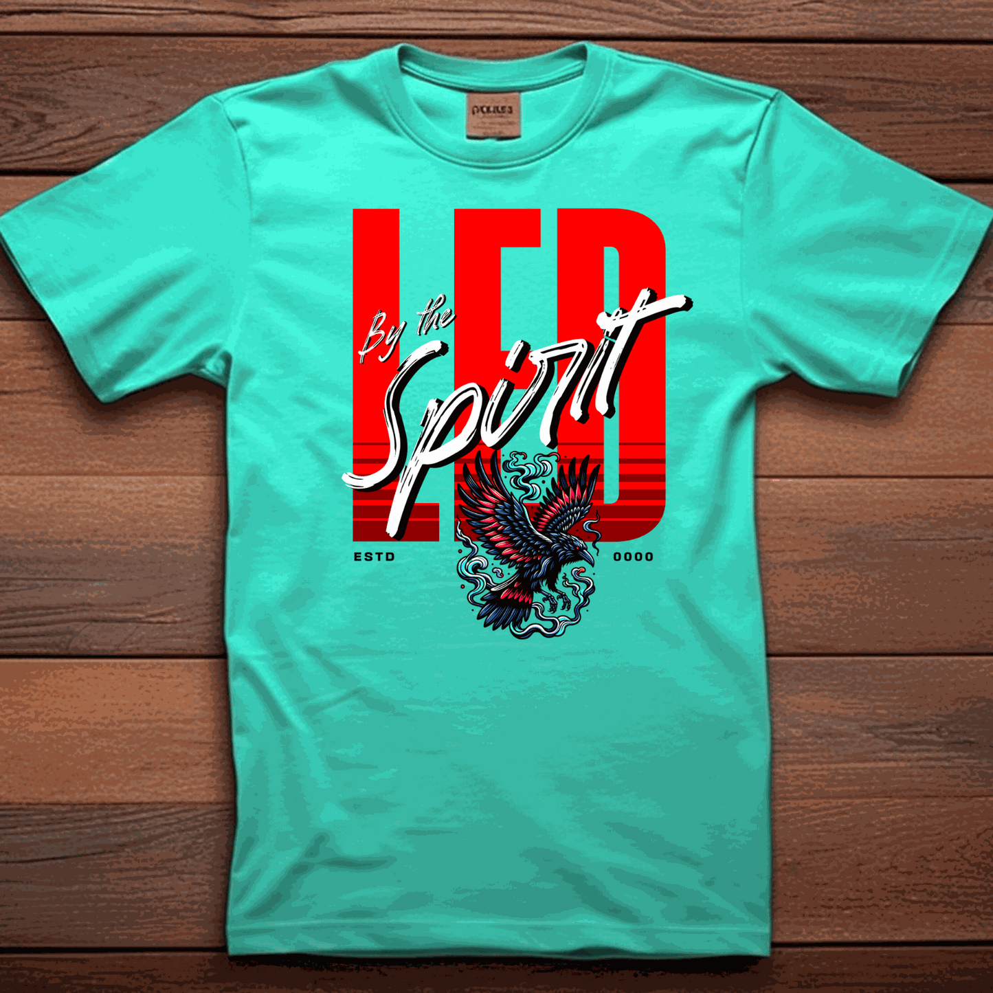 Christian LED Unisex T-shirt in turquoise with bold red and white "LED by the Spirit" text and eagle graphic.