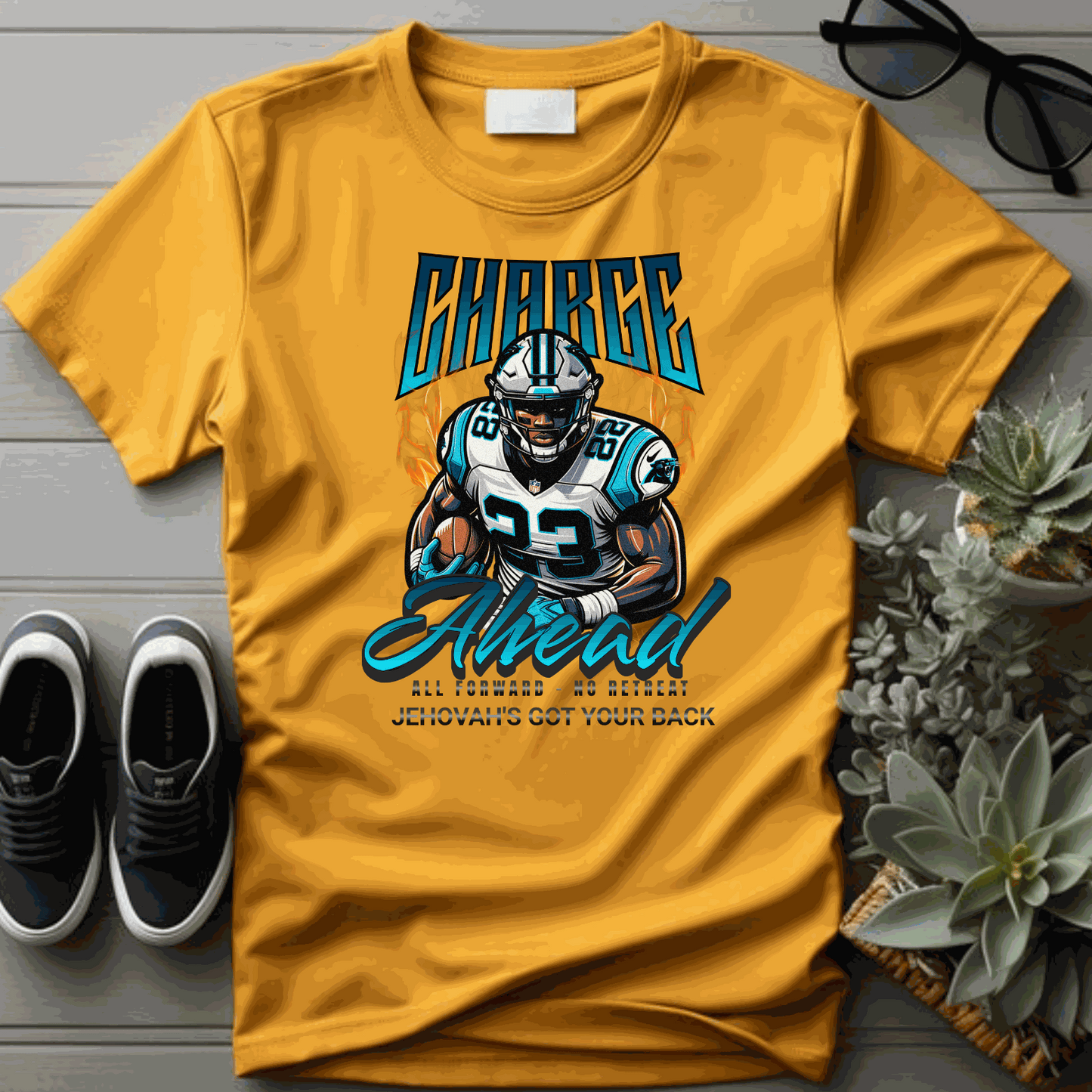 Yellow Charge Ahead Unisex softstyle T-shirt with a football player graphic and motivational text, styled with casual accessories on a wooden surface.