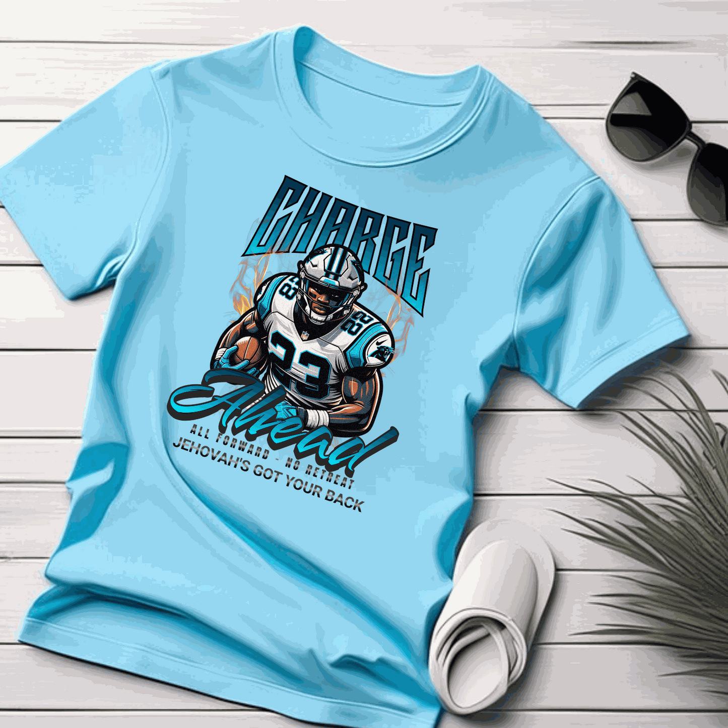 Charge Ahead Unisex softstyle T-shirt in light blue with football player graphic and motivational text.